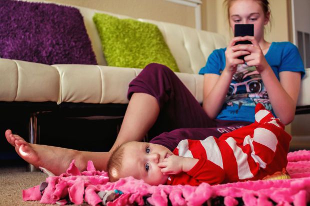 babysitter-on-phone-ignoring-baby